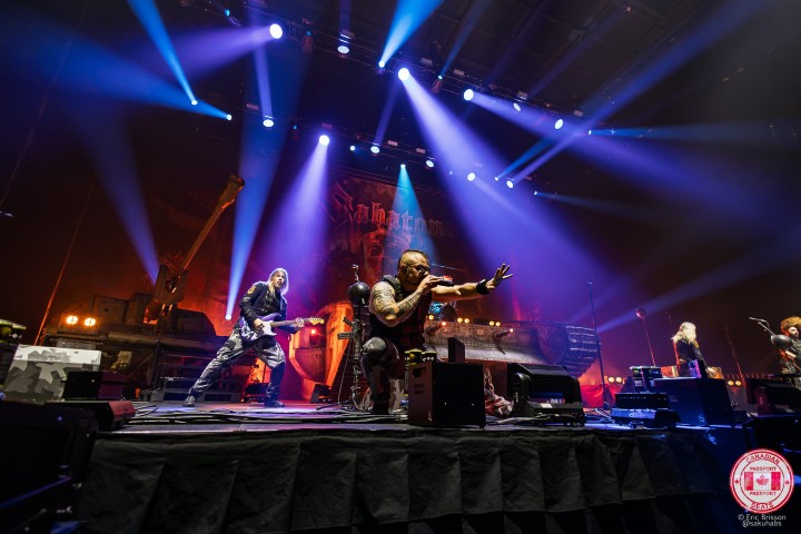 Sabaton performing live at Place Bell in Laval, Quebec, during an explosive heavy metal concert.