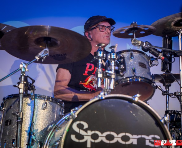 Spoons drummer performing behind a silver drum kit with the band's logo at Maxwell's in Waterloo.